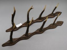 A pair of antler gun rack holders