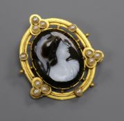 A Victorian oval yellow metal and split pearl framed carved hardstone cameo portrait brooch,