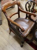 A mid Victorian mahogany open armchair, with openwork back, hide upholstered seat, on turned and