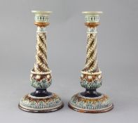 A pair of Doulton Lambeth stoneware candlesticks, with applied spiral fluted decoration, height