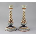 A pair of Doulton Lambeth stoneware candlesticks, with applied spiral fluted decoration, height