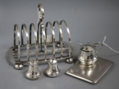 A silver cigarette case, a three-piece silver condiment set and a plated toast rack from the sailing