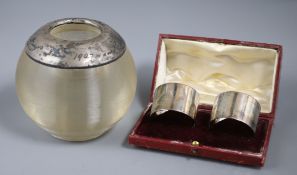 A large George V silver mounted match strike and a pair of Edwardian silver serviette rings (3)ex