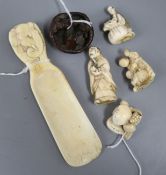 A group of Japanese ivory netsuke and other small carvings, including a shoehorn with elephant