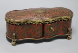 A boulle gilt metal mounted shaped rectangular casket, with lifting top and two doors, inlaid with