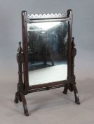 After A.W.N. Pugin - a Victorian Gothic revival carved mahogany swing frame toilet mirror W.63cm,