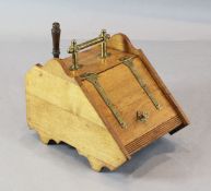 A Victorian oak and brass bound coal box with shovel, with sloping top, brass strap hinges and