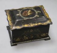 An early Victorian papier mache rectangular tea caddy, the interior with two covered sections,