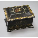 An early Victorian papier mache rectangular tea caddy, the interior with two covered sections,