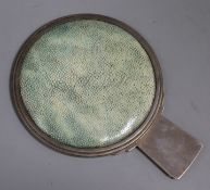 A late 1920's Art Deco silver and shagreen mounted circular hand mirror, the handle cast with the