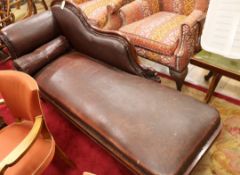 An early Victorian mahogany framed chaise longue, on reeded turned and tapering legs with brass feet