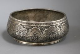 A Persian engraved white metal bowl, on circular foot, 16.5cm.