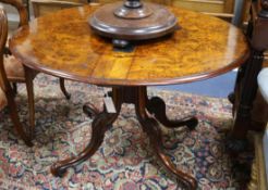 A late Victorian burr walnut Sutherland table, with oval double flap top and with gateleg action, on