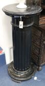 An ebonised fluted column statuary pedestal and another, on turned and fluted tapering support