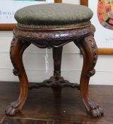 A Victorian carved walnut adjustable piano stool