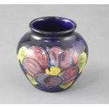 A Moorcroft 'Anemone' vase, of bulbous form, blue ground, signed to base, H 8cm