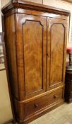 A Victorian mahogany wardrobe, with moulded cornice, fitted two panelled doors and with a drawer