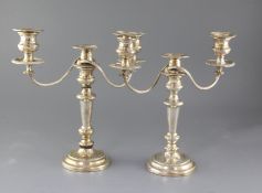 A pair of silver plated two branch three light candelabra, one (a.f), 35.2cm.