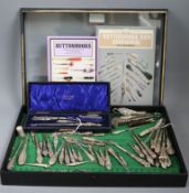 A cased silver-mounted shoehorn and buttonhook set, a collection of buttonhooks and sundries, the