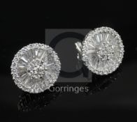 A modern pair of 18ct white gold and diamond target earrings, set with round and trapeze cut