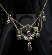 An early 20th century continental gold and garnet set drop necklace, set with ten shaped cut