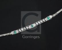A 1920's 18ct white gold and platinum, emerald and diamond bracelet, set with three square cut