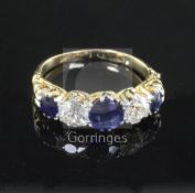 An early 20th century gold and platinum, sapphire and diamond five stone half hoop ring, with carved