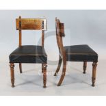 A set of four Victorian oak and ebonised dining chairs, manner of J.P. Seddon with chip carved