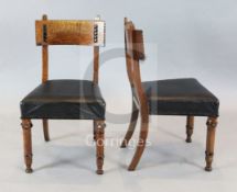 A set of four Victorian oak and ebonised dining chairs, manner of J.P. Seddon with chip carved