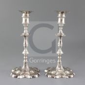 A pair of early George III cast silver candlesticks by Ebenezer Coker, with waisted knopped stems