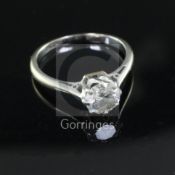 An 18ct white gold and platinum solitaire diamond ring, the round brilliant cut stone weighing