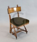 A Reformed Gothic oak dining chair, designed by Edward Welby Pugin, c.1864, with revealed pegs to