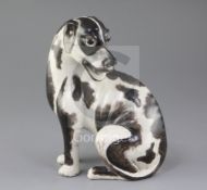 A Chinese export model of a seated hound, first half 18th century, the dog painted with black enamel