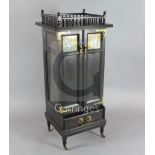 An Aesthetic movement ebonised music cabinet, in the manner of Morris & Co., with a spindled gallery