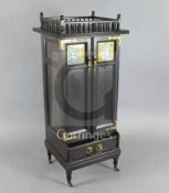 An Aesthetic movement ebonised music cabinet, in the manner of Morris & Co., with a spindled gallery