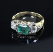 A 19th century gold, single stone emerald and two stone diamond ring, the emerald measuring 7.0 mm