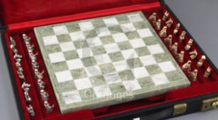 A cased 1960's chess set with a white and green marble chess board and thirty two 9ct gold chess