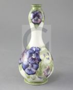 A Moorcroft double gourd vase decorated with pansies, cream ground, green painted signature W.