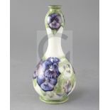 A Moorcroft double gourd vase decorated with pansies, cream ground, green painted signature W.