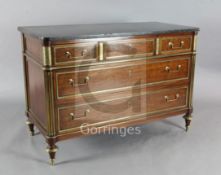A French Directoire brass mounted mahogany commode, with fossilised marble top, and four long