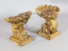 A pair of Venetian carved giltwood grotto stools, each modelled as a dolphin, on simulated marble