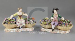 A pair of Minton figures with baskets, c.1840, on scrollwork bases, width 19.5cm, some restoration