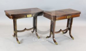 A pair of Regency brass inset rosewood card tables, with D shaped folding tops, on squared end