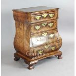 A 19th century Dutch walnut bombe commode, with feather banding, fitted four long drawers, on ogee