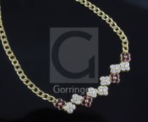 A Garrard & Co 18ct yellow gold curb-link necklace, with seven diamond and four ruby conjoined