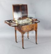 An Edwardian satinwood toilet table, with hinged lid enclosing a fitted interior with silver mirror,