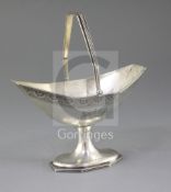 A George III Irish silver boat shaped sugar basket by Robert Breading?, with bright cut engraving
