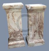 A near pair of square section pink veined marble pedestals, W.1ft 6in. D.1ft 4in. H.3ft 8in.