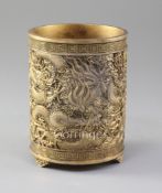 A Chinese gilt copper brush pot, Bitong, possibly Qing dynasty, cast in relief with dragons