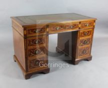 A late Victorian mahogany and marquetry pedestal writing desk, with leather inset top, fitted nine